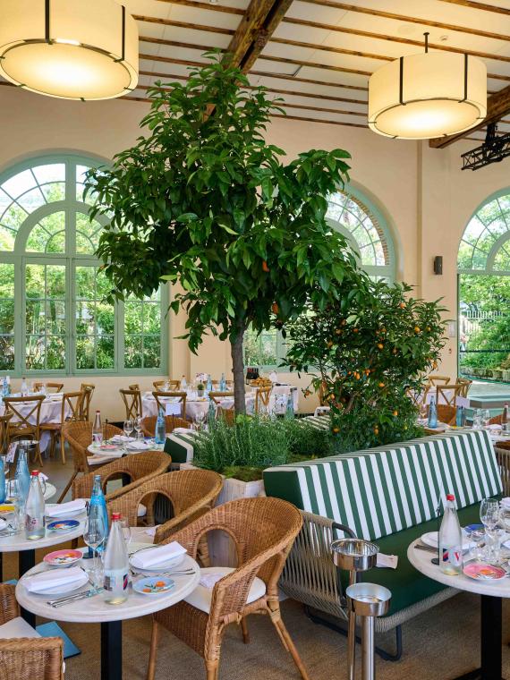 The interior of the cozy and elegant area of the Orangerie and its tables at Roland-Garros