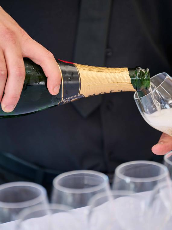 A waiter serving champagne at the Salon Ferveur VIP hospitality area at the Stade de France