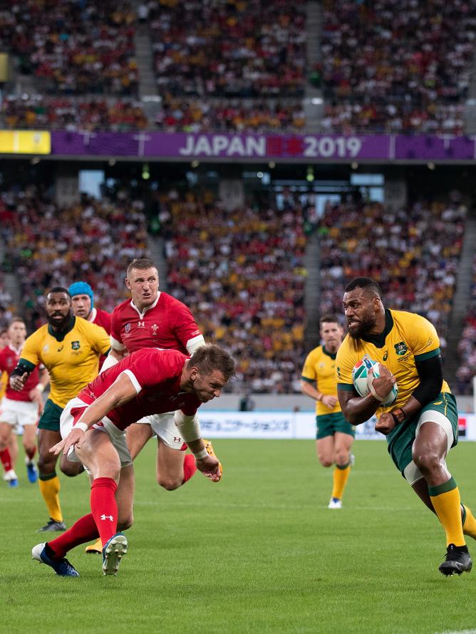 Rugby players from the Australia and Wales teams on the pitch during a Rugby World Cup match