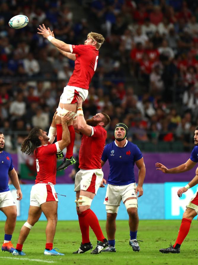 Rugby players from the France and Wales teams on the pitch during a Rugby World Cup match