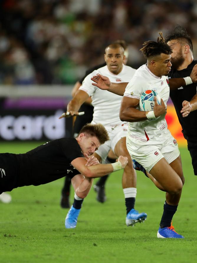 Rugby players from the England and New Zealand teams on the pitch during a Rugby World Cup match