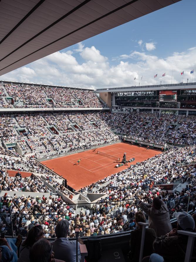 A daytime view of the Court Philippe-Chatrier at Roland Garros from the stands during a match